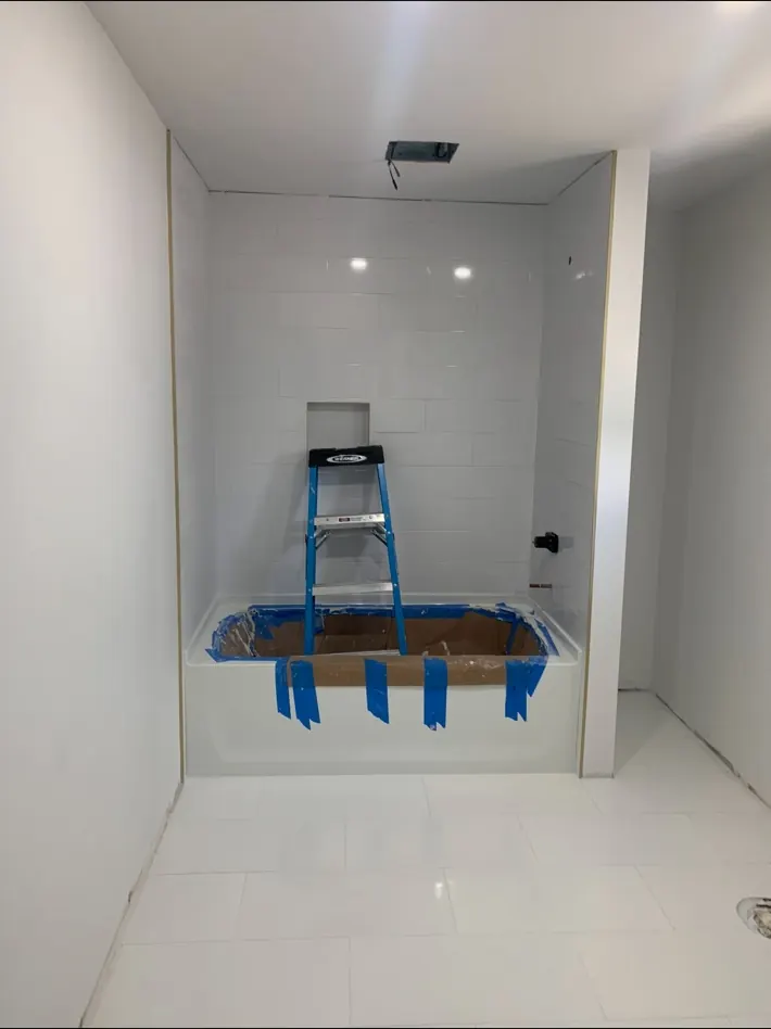 Bathroom tub surround and tile installation in progress