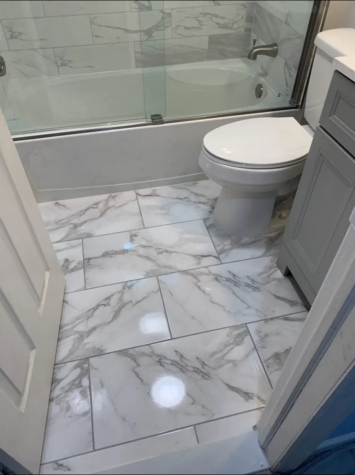Finished bathroom tile floor and fixtures